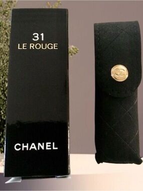 Chanel 31 Le Rouge lipstick case, a black quilted velvet pouch.